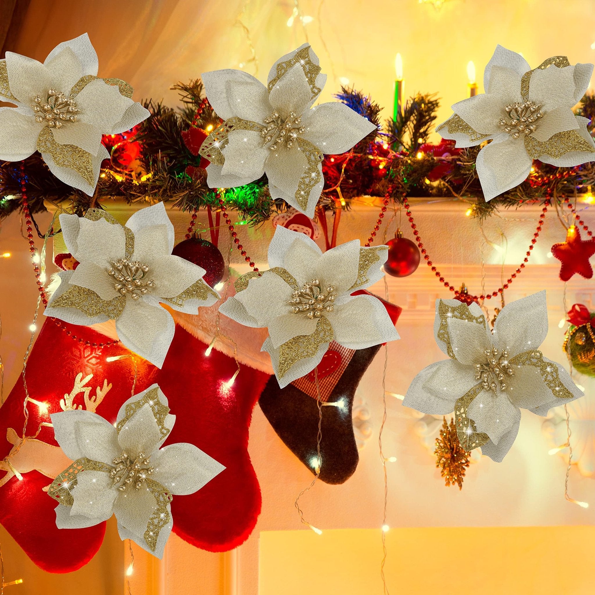 Six gold glitter artificial poinsettia flowers with metal clips arranged on a festive Christmas mantelpiece with stockings and lights.
