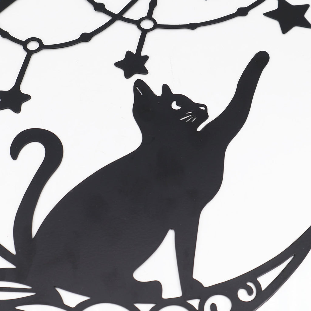 Black metal moon cat wall decor with stars, close-up of cat reaching up
