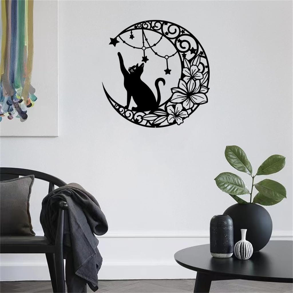 Black metal moon cat wall decor with stars and flowers, displayed on a white wall above a chair and table.