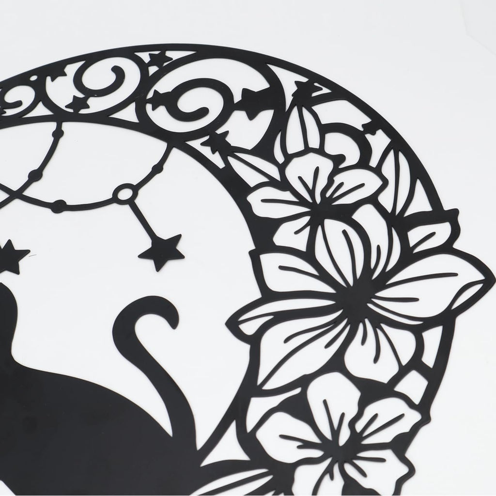 Black metal moon cat wall decor with floral and star accents, close-up detail