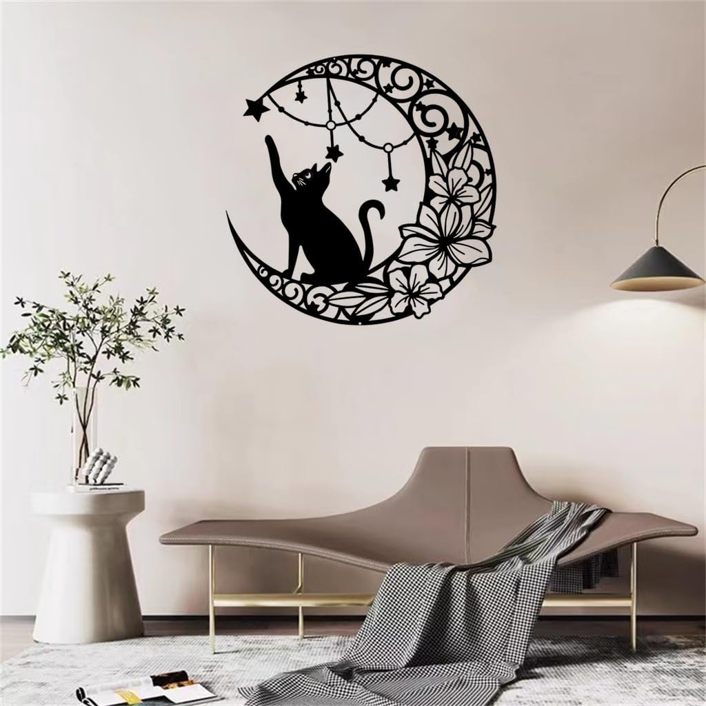 Black metal moon cat wall decor with stars and flowers hanging on a wall above a sofa