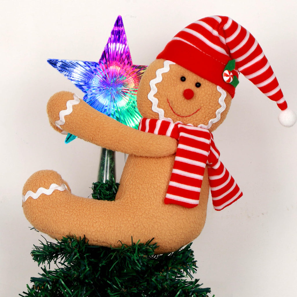 Gingerbread man tree topper with lighted star on a Christmas tree branch