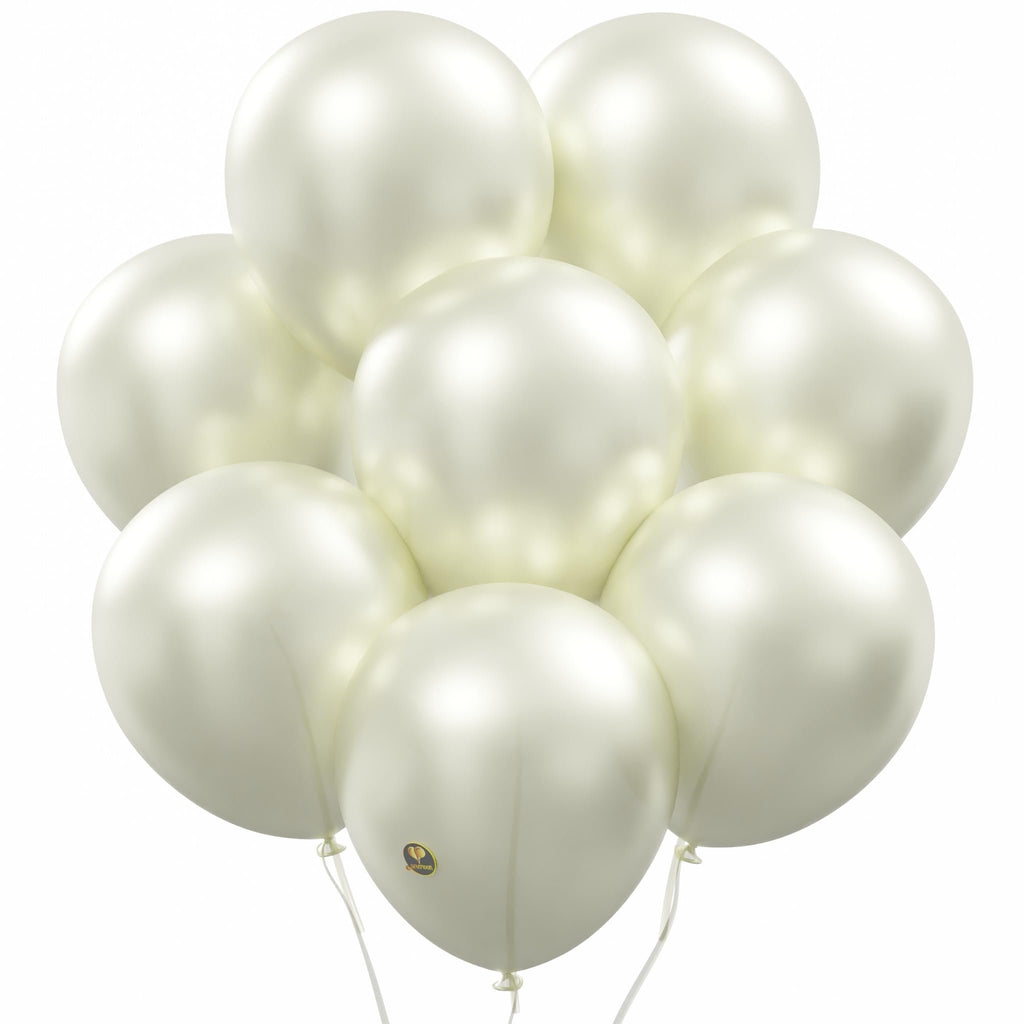 Cluster of pearlized white latex balloons with white strings against a white background.