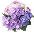 Artificial silk hydrangea and rose bouquet in shades of purple and pink, with green leaves, isolated on white.