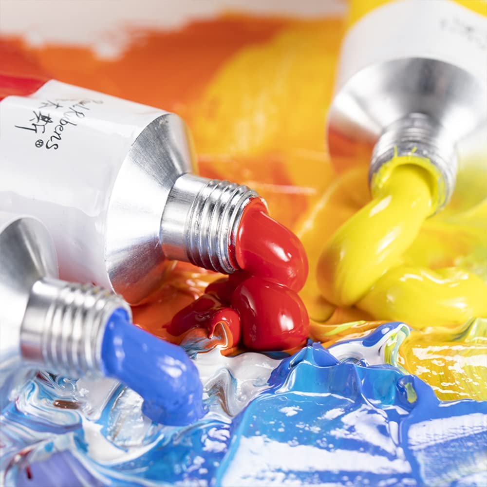 Three tubes of oil paint dispensing red, yellow, and blue onto a palette.