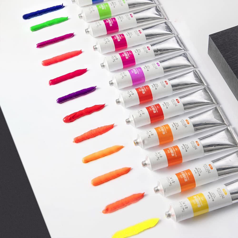 12 tubes of neon oil paint with swatches of color laid out on a white surface