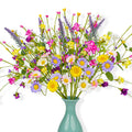 Artificial spring floral arrangement with daisies, wildflowers, and pip berries in a teal vase.