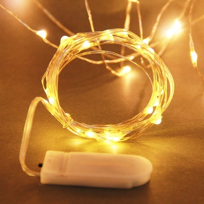 Battery operated fairy lights coiled with a white battery pack, warm white LEDs