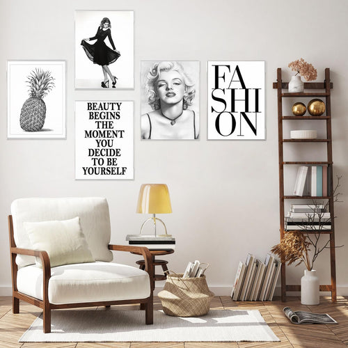 Living room scene with five framed art prints on the wall, a white armchair, and a wooden ladder shelf.