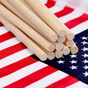 Bundle of 12 wooden flagpoles resting on an American flag.
