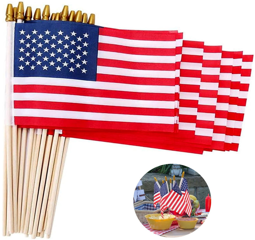 Pack of 12 American stick flags with wooden poles and gold spear tops, shown fanned out with a circular inset of flags decorating a picnic table.
