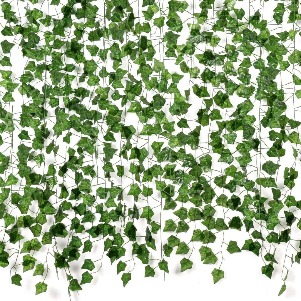 Artificial ivy vines with green silk leaves and plastic stems cascading against a white background.