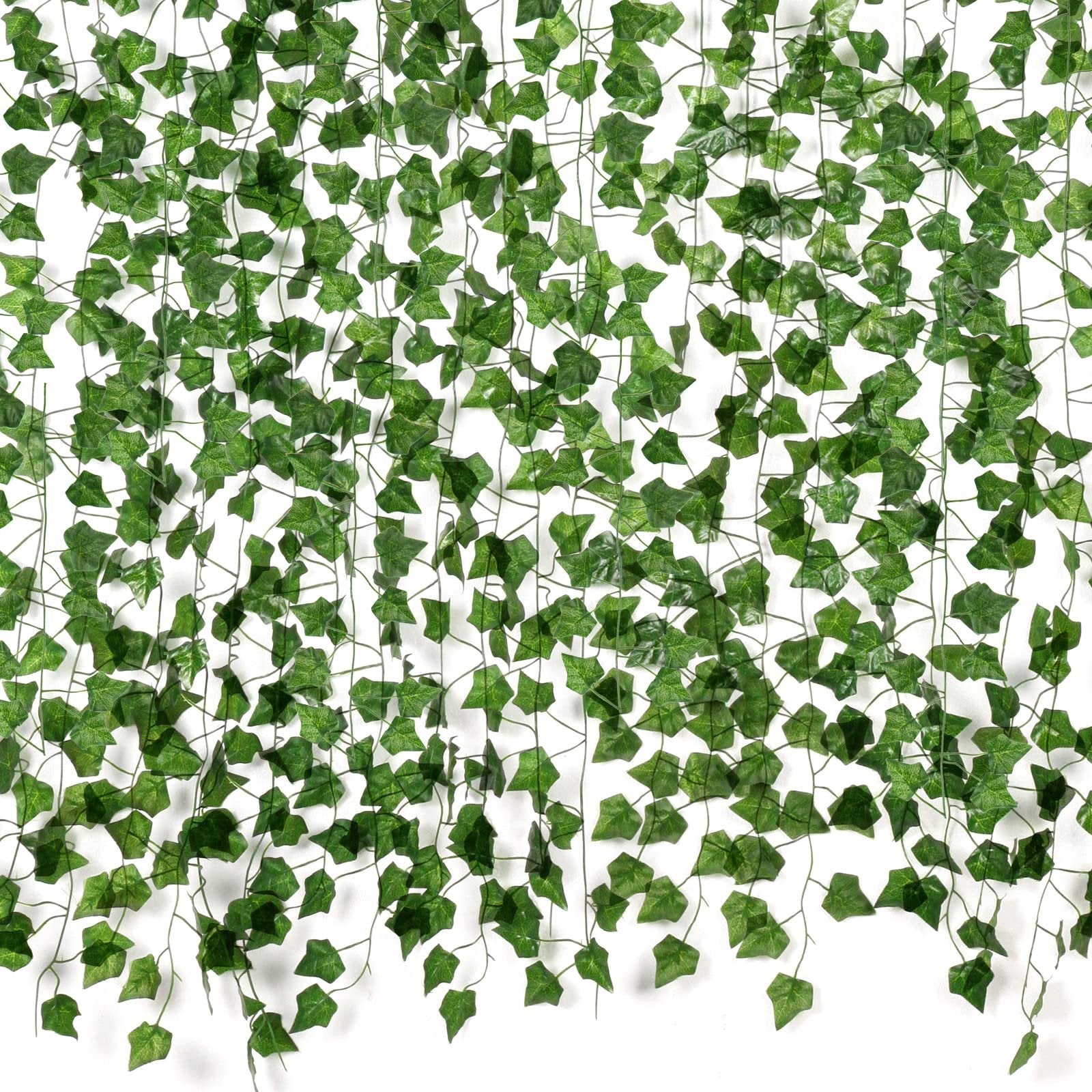 Artificial ivy vines with green silk leaves and plastic stems cascading against a white background.