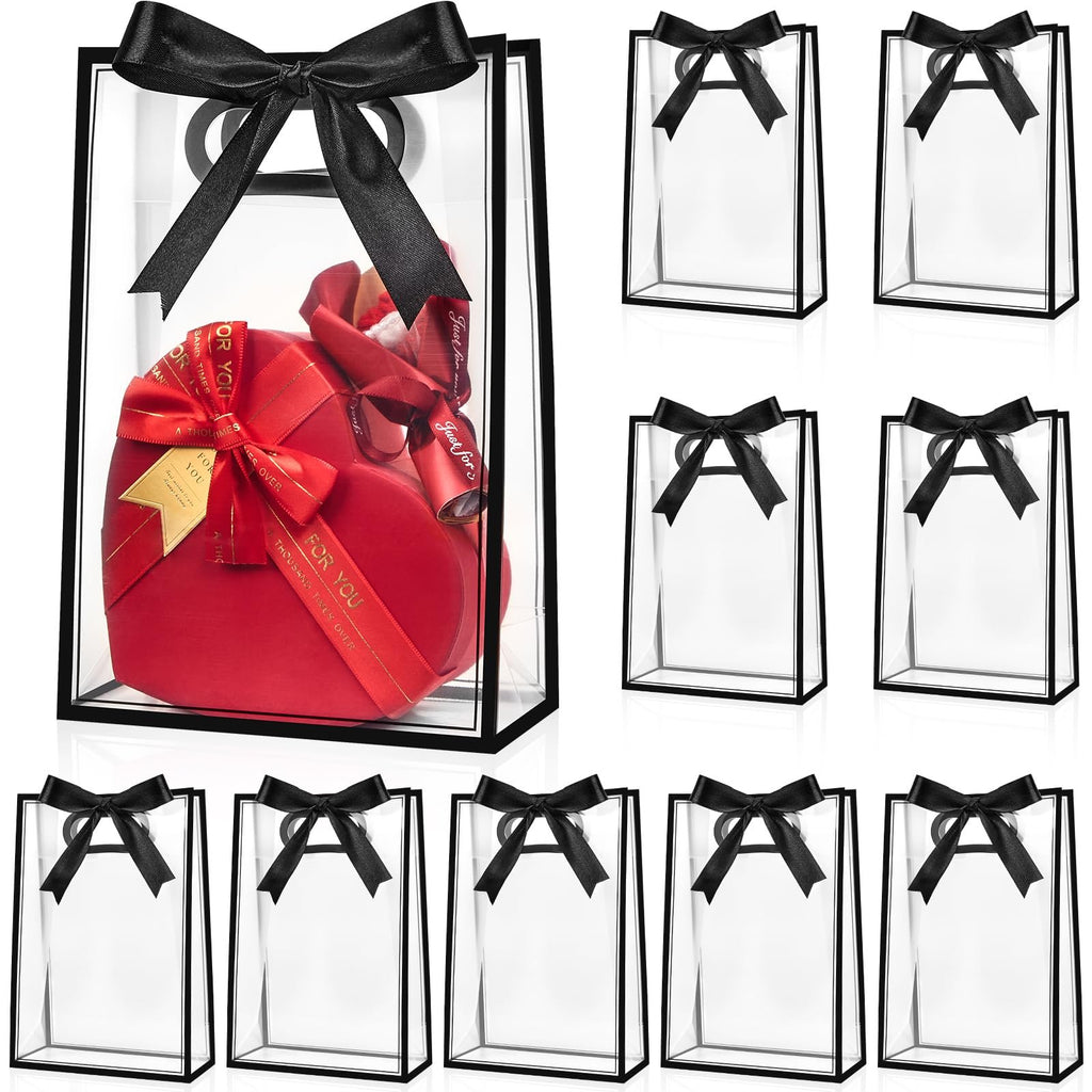 Clear plastic gift bags with black ribbon bows, one bag contains a red heart-shaped gift box.