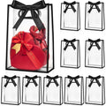 Clear plastic gift bags with black ribbon bows, one bag contains a red heart-shaped gift box.