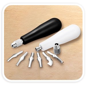 Two handles and assorted V and U shape linoleum cutter blades on a textured background