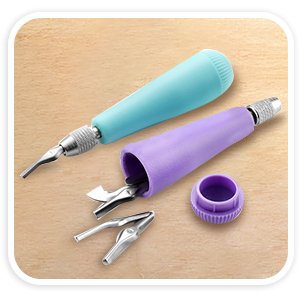 Two craft linoleum cutter handles, one teal and one purple, with assorted V and U shape blades and a cap on a light brown surface.