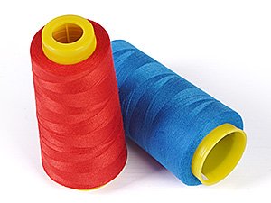Two polyester serger thread cones, one red and one blue, with yellow plastic caps, on a white background.