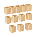12 unfinished pine wood pen holders arranged in three rows on a white background.