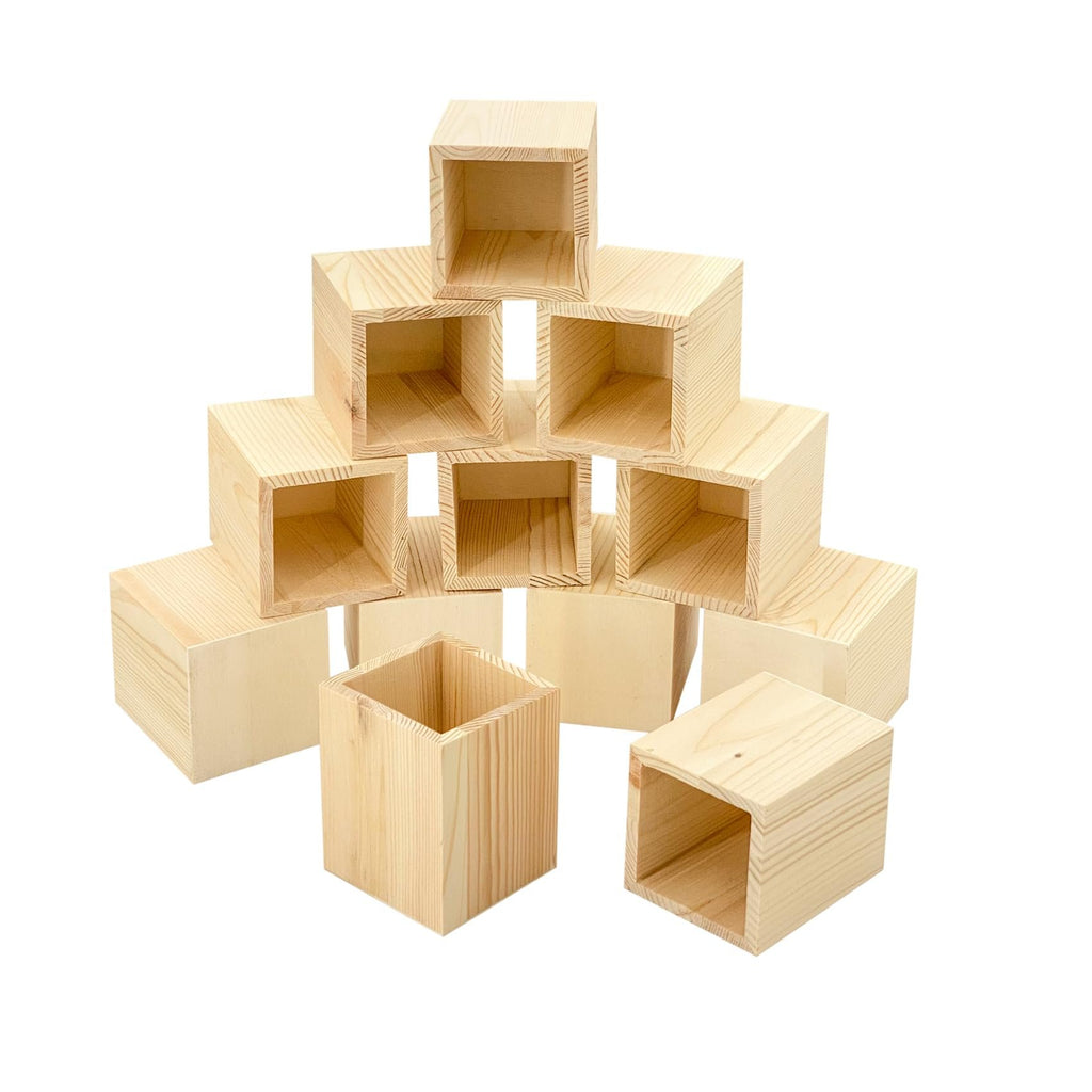 Stack of 12 unfinished pine wood pen holders, 3x3x4 inches, arranged in a pyramid shape on a white background.