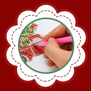 Hand using pink tool to apply resin gems to a Christmas ornament keychain diamond art kit