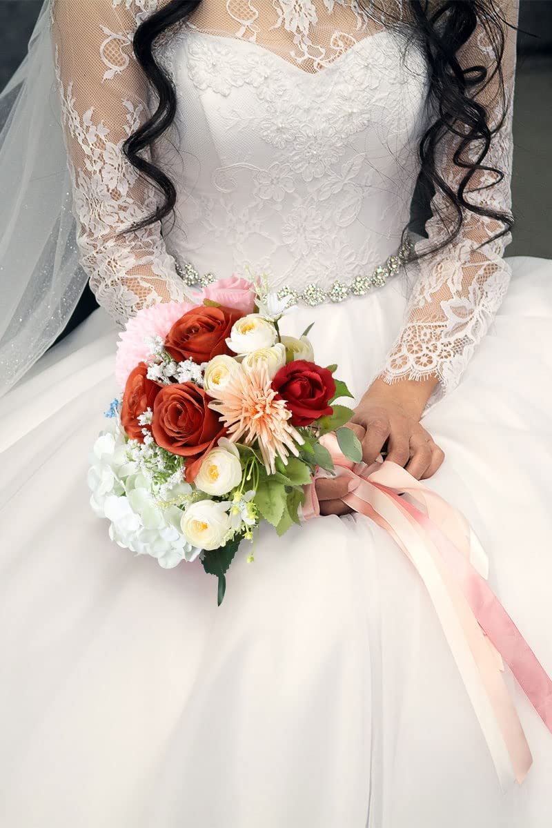 Bride holding a bouquet of burnt orange and red roses with white and cream accents, adorned with ribbons.