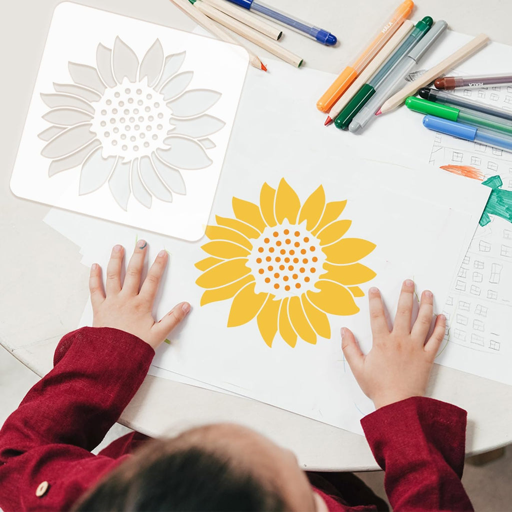 Child's hands using a sunflower stencil to create art with markers and pencils on paper.