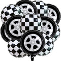 Pile of race car themed foil balloons, some with checkered patterns and others designed as car wheels.
