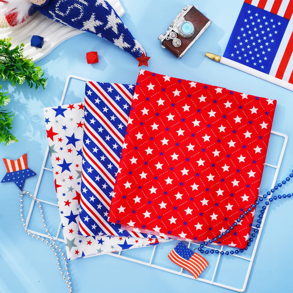 Three patriotic fat quarter fabric bundles with stars and stripes patterns on a white rack, surrounded by decorative items.