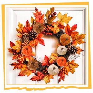 Fall wreath with velvet pumpkins, pinecones, and autumn leaves on a white door