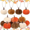 Set of 12 velvet pumpkins in orange, brown, khaki, and cream white, with hanging loops.