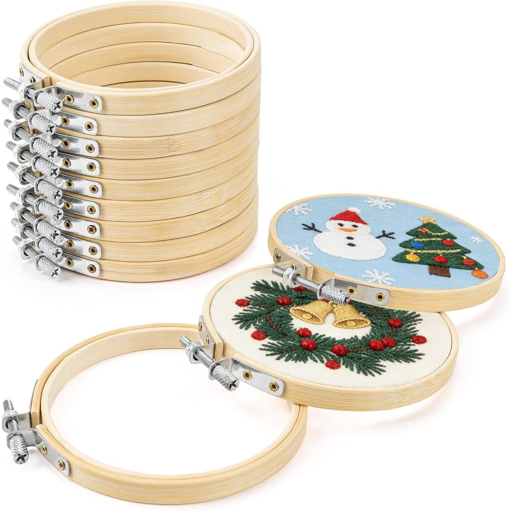 Stack of 12 bamboo embroidery hoops with two hoops showing Christmas designs in the foreground