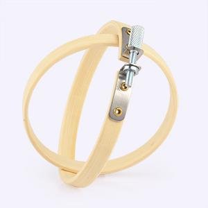 Two natural wood embroidery hoops with brass screw hardware, shown at an angle against a white background.