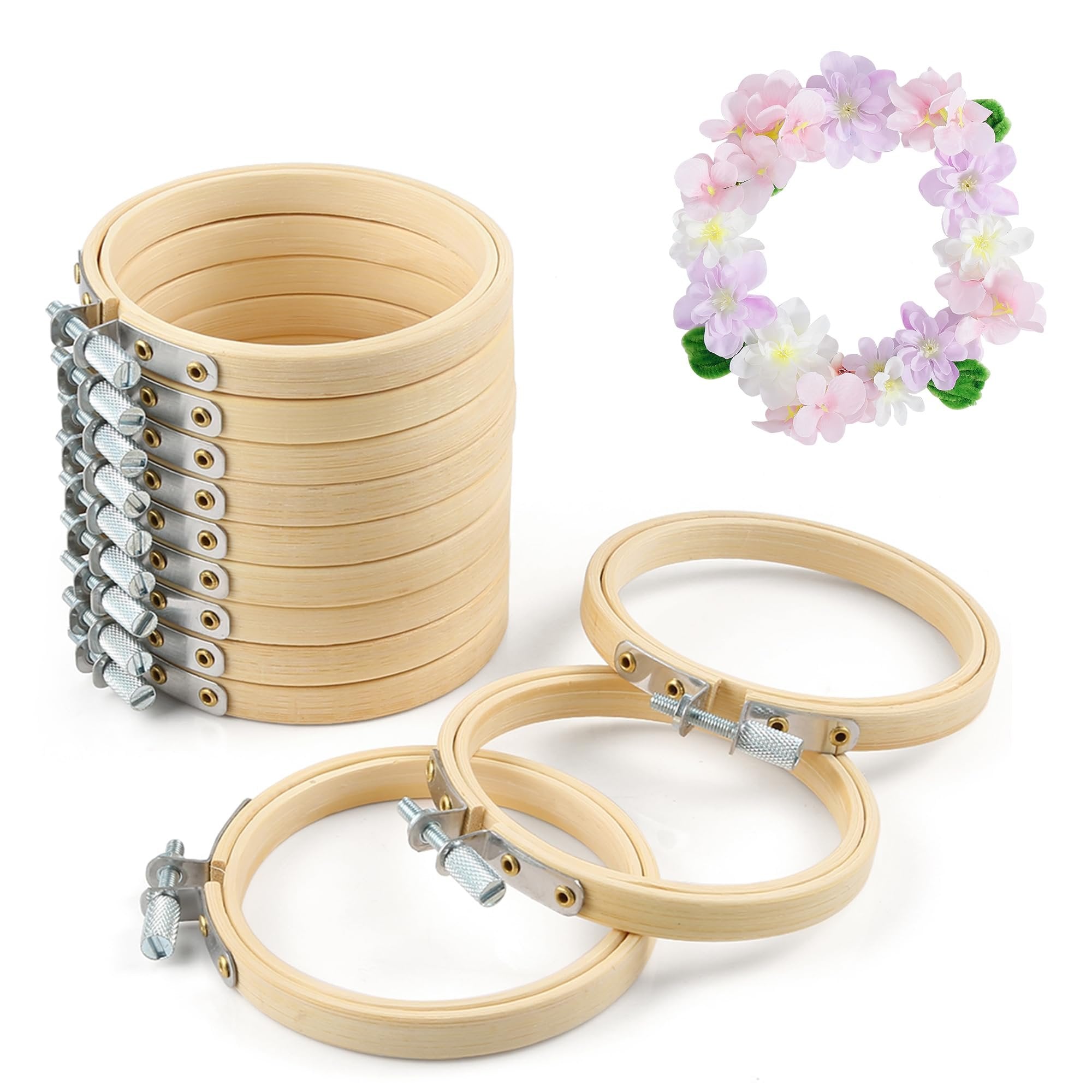 Stack of 12 round wooden embroidery hoops with brass screws and a decorative floral wreath on white background