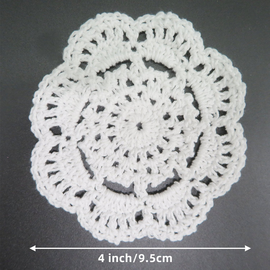 White handmade crochet lace doily shown from above with a 4 inch/9.5cm measurement indicator below.