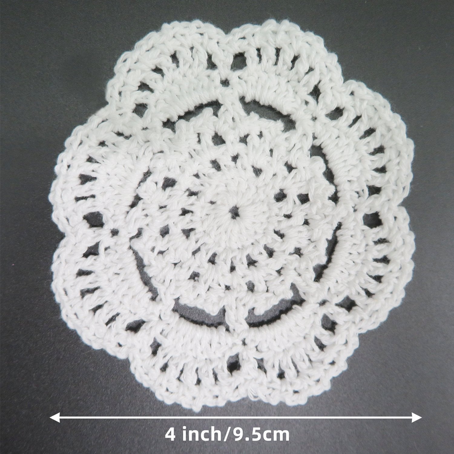 White handmade crochet lace doily shown from above with a 4 inch/9.5cm measurement indicator below.