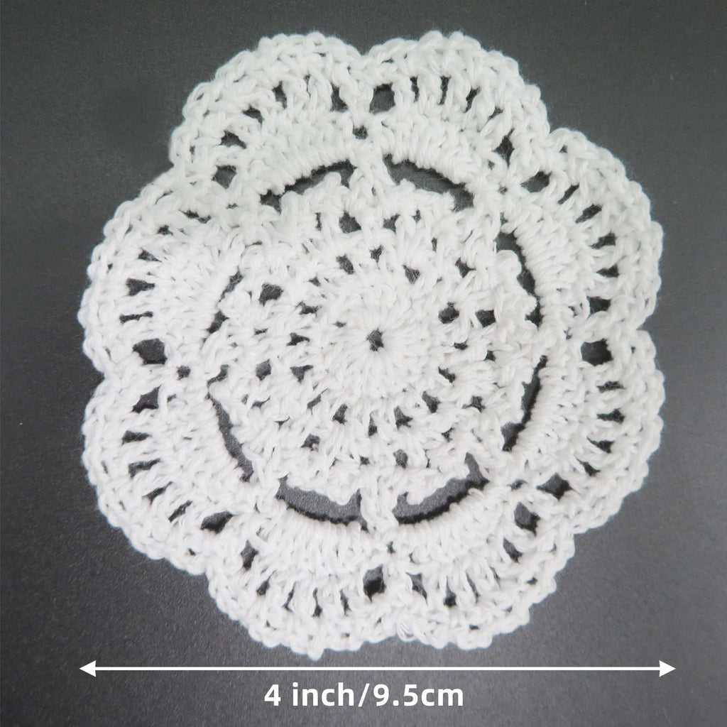 White handmade cotton crochet lace doily shown from above, with a 4 inch/9.5cm measurement indicator.