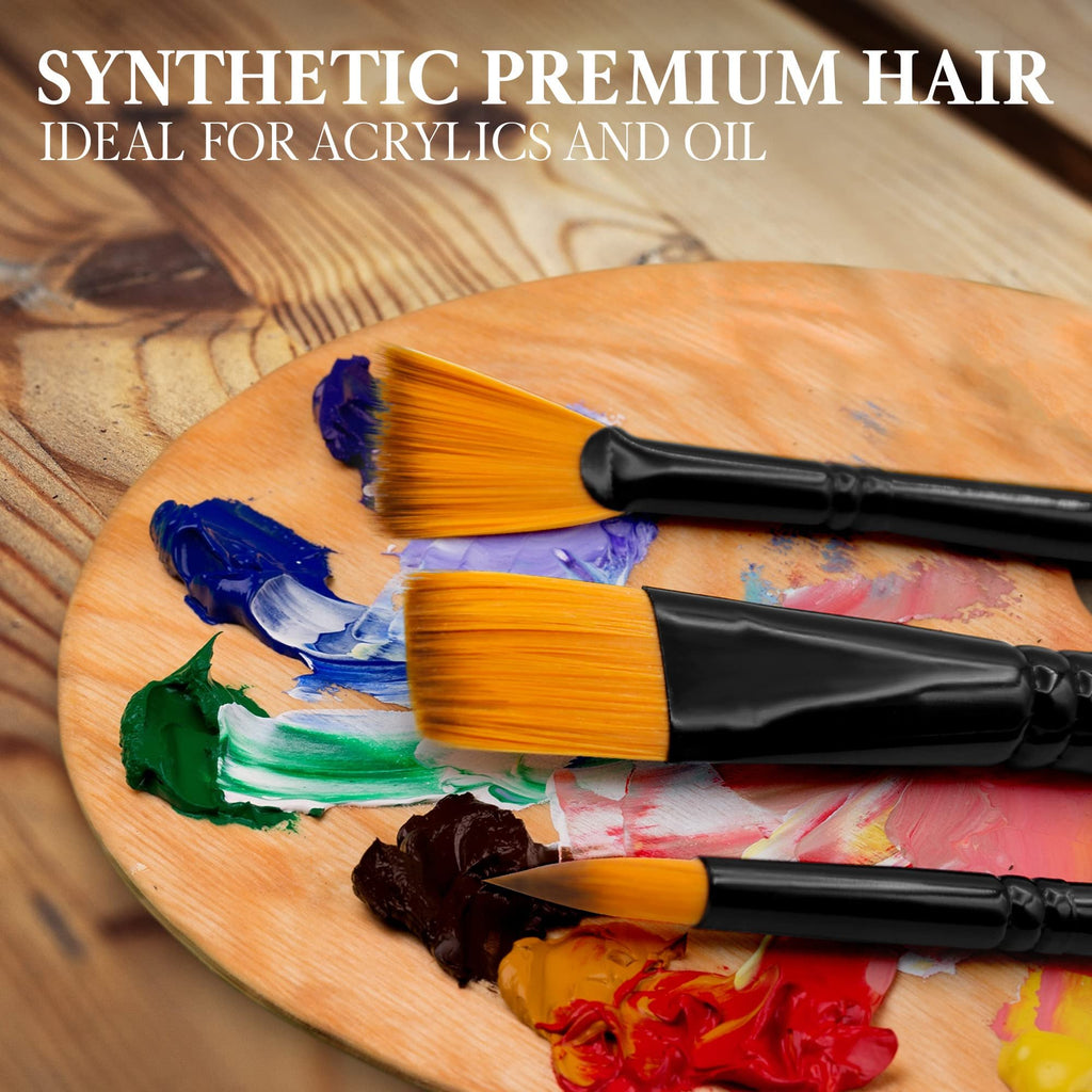 Three paint brushes with synthetic bristles on a wooden palette with colorful oil paints.