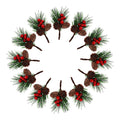 Twelve artificial Christmas pine branches with red berries and pine cones arranged in a circle on a white background.