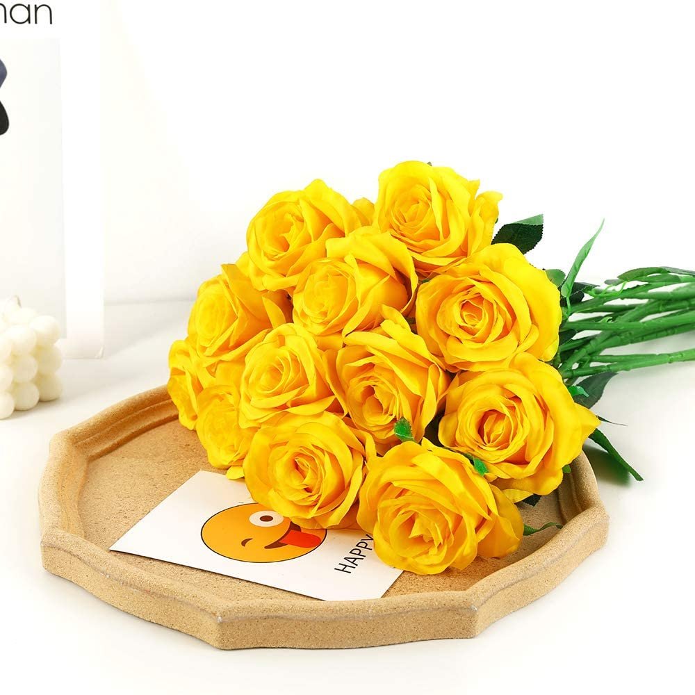 A bouquet of 12 yellow artificial silk roses with green stems arranged on a hexagonal tray with a card featuring a happy emoji and the word HAPPY.