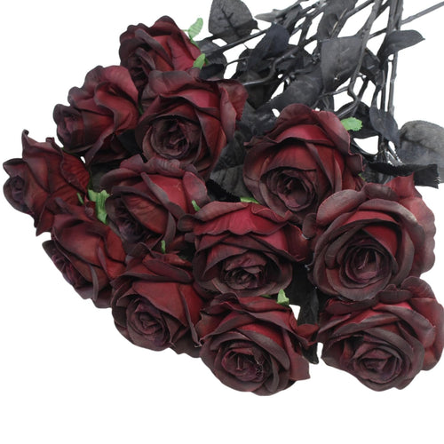 Bouquet of 12 burgundy artificial roses with dark stems and leaves, shown from a top-down angle against a white background.