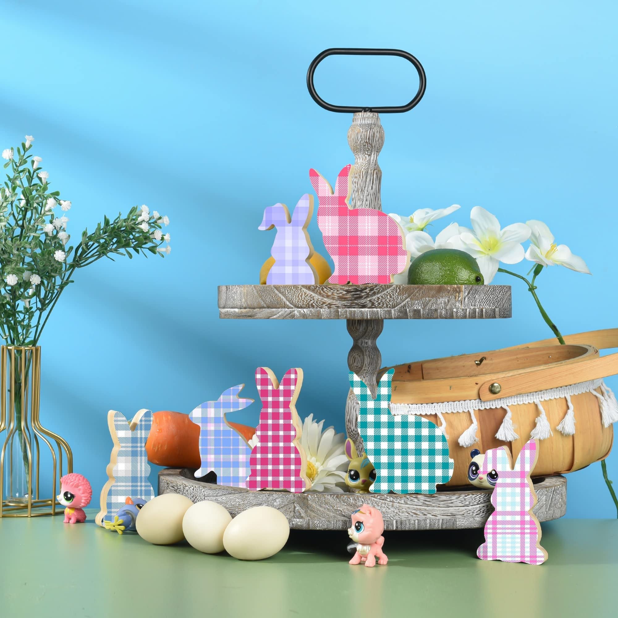 Easter tiered tray display with plaid wooden bunny cutouts, eggs, flowers, and a basket.