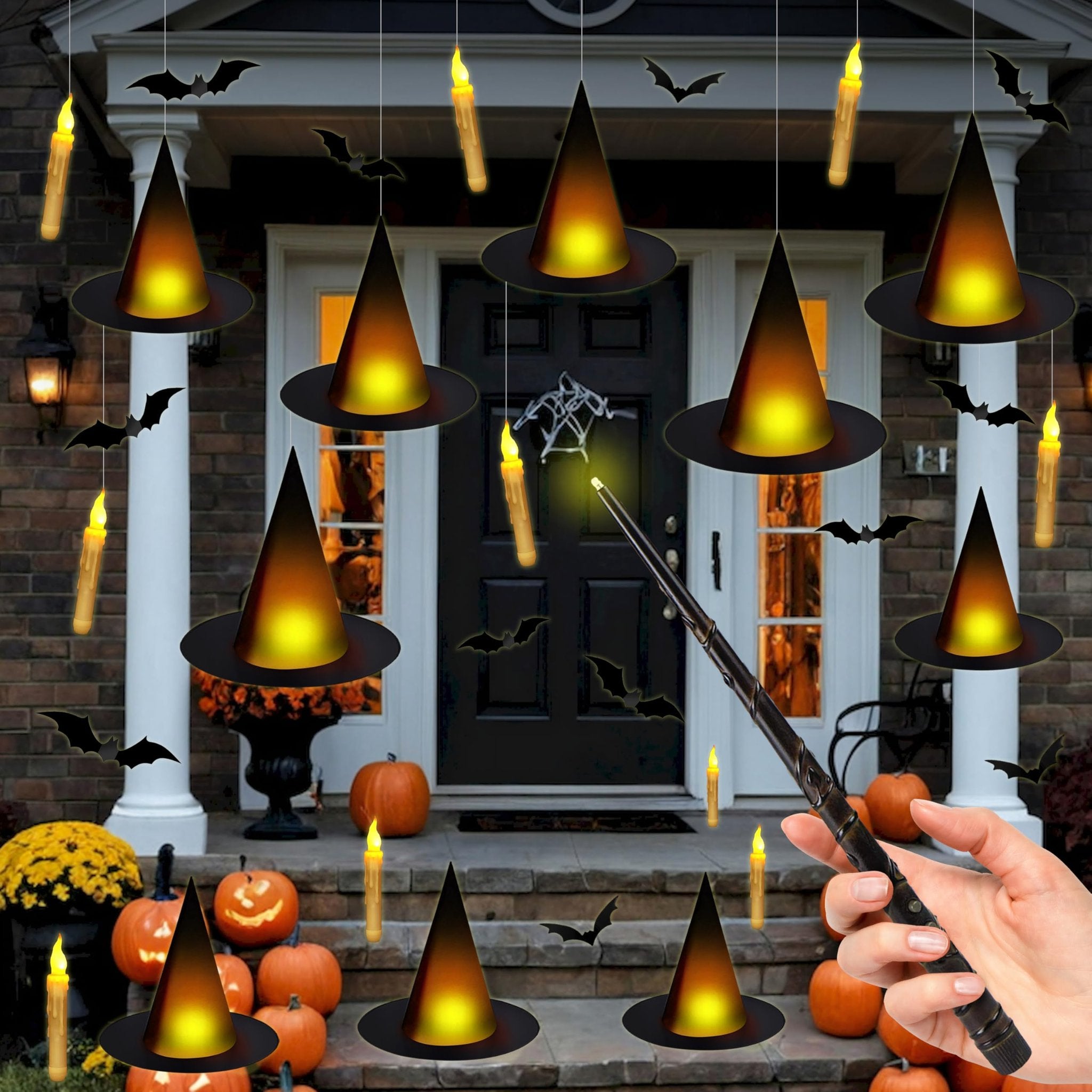 Halloween porch decor with floating witch hats, flameless candles, and bat cutouts, a hand holds a wand.