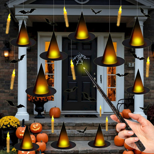 Halloween porch decor with floating witch hats, flameless candles, and bat cutouts, a hand holds a wand.