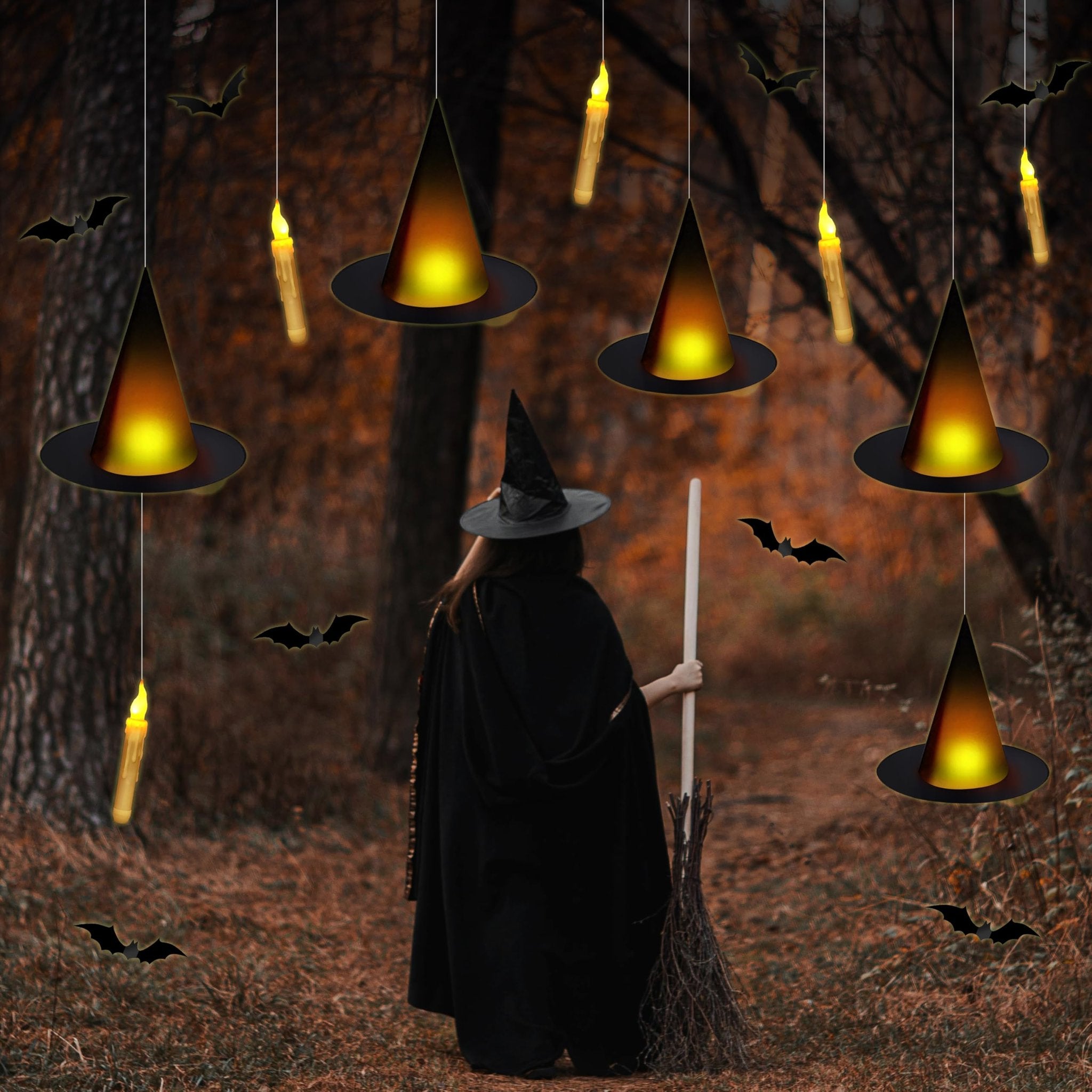 Halloween scene with a person in a witch costume holding a broomstick, surrounded by hanging witch hats and flameless candles.