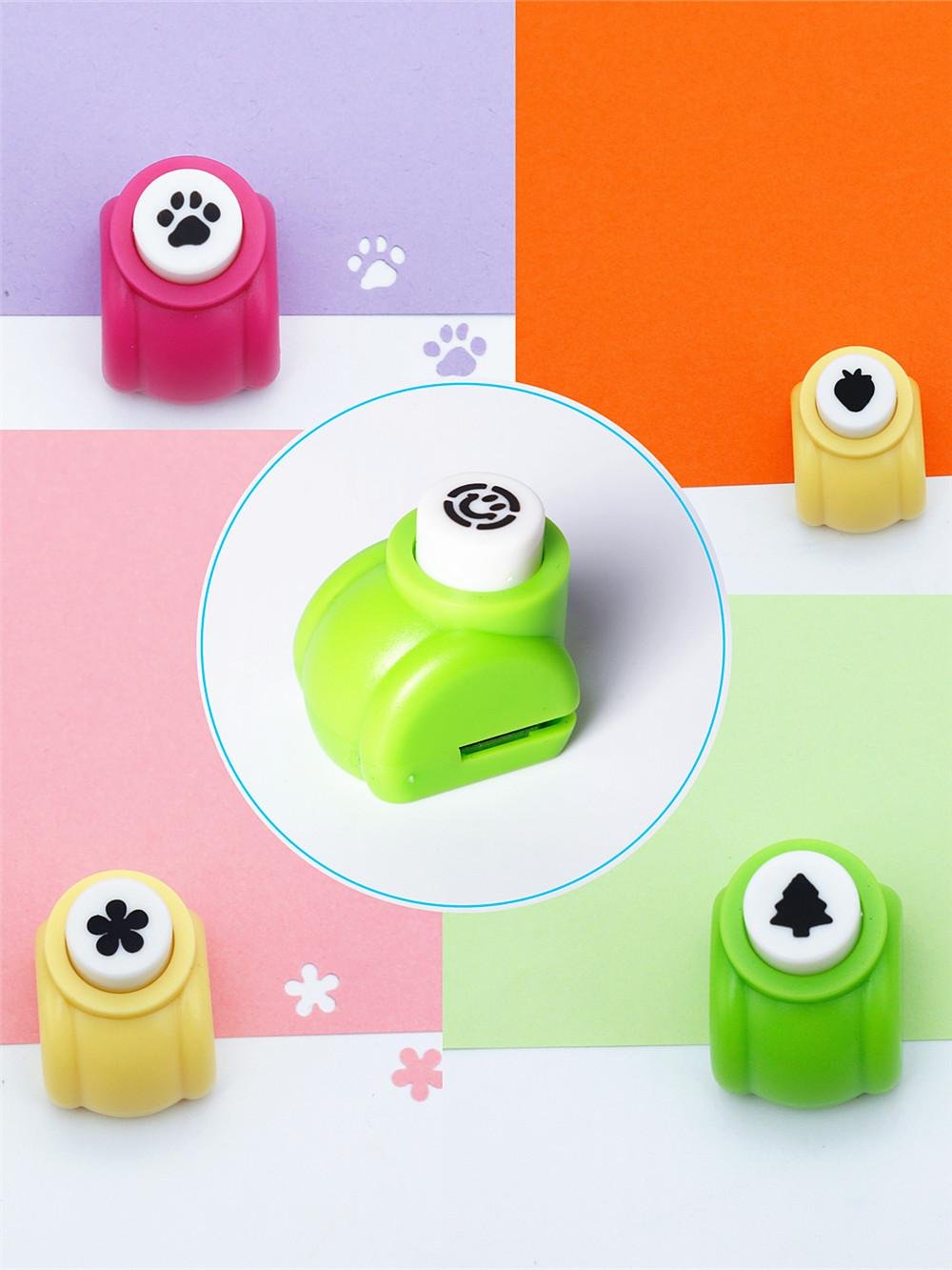 Assorted mini craft hole punches with paw print, swirl, flower, strawberry, and Christmas tree designs.