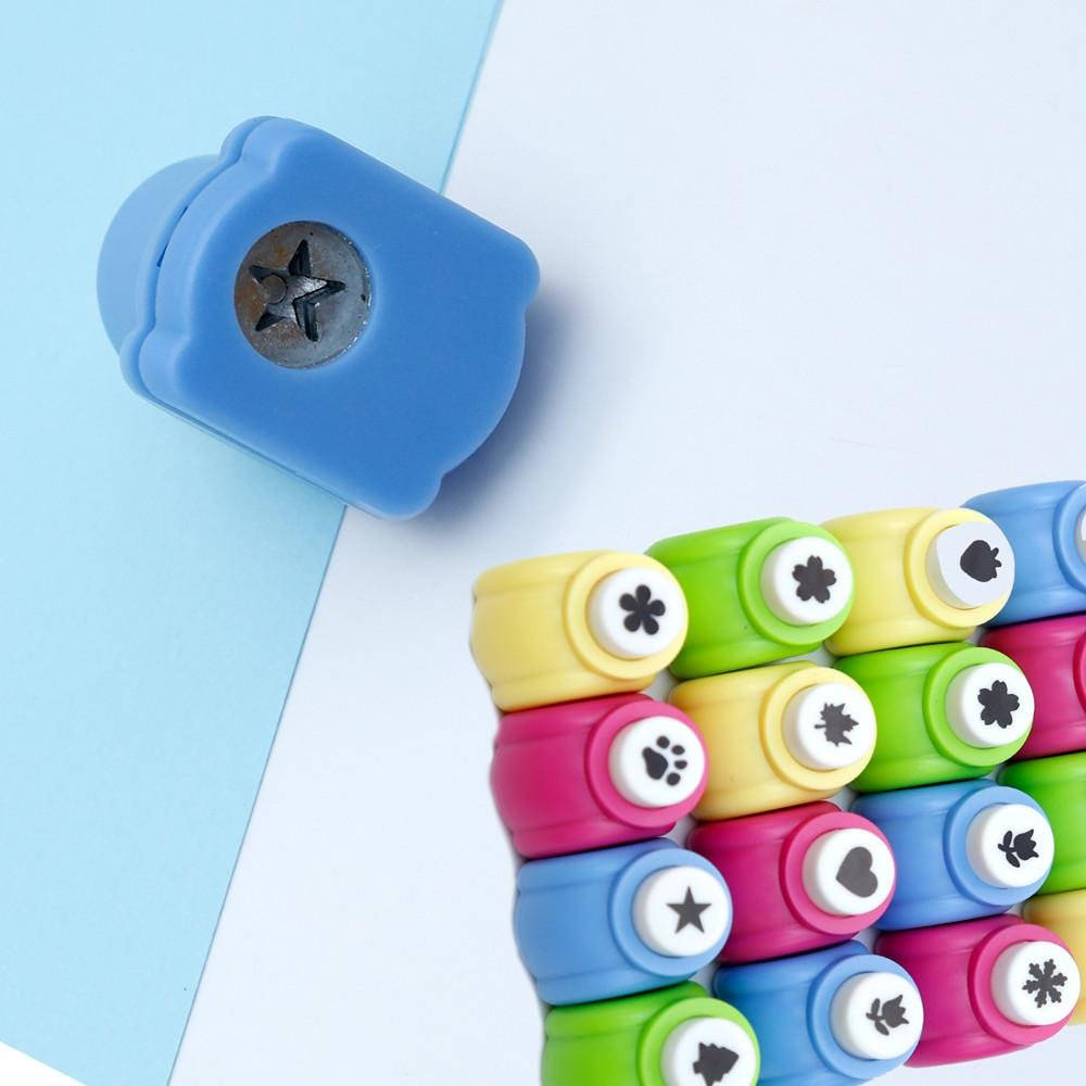 Assorted mini craft hole punches in various colors, stacked and arranged, showing star, paw print, heart, leaf, and flower shapes.