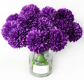 Bouquet of 12 purple artificial ball chrysanthemum flowers in a glass vase on a white background