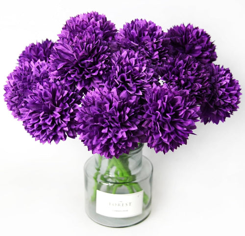 Bouquet of 12 purple artificial ball chrysanthemum flowers in a glass vase on a white background