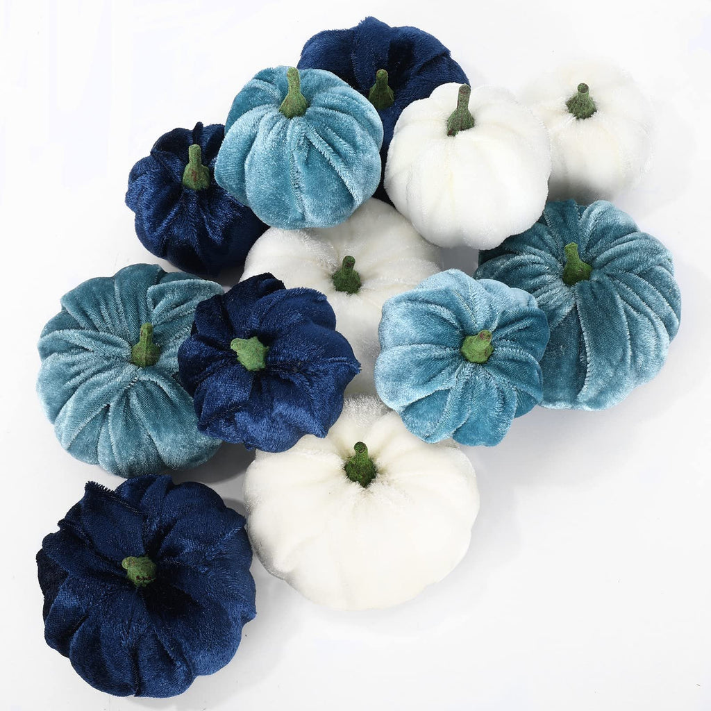 A collection of 12 velvet artificial pumpkins in various shades of blue and white, arranged on a white background.